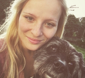 Junge Studentin mit schwarzem Hund im Freien, Nahaufnahme